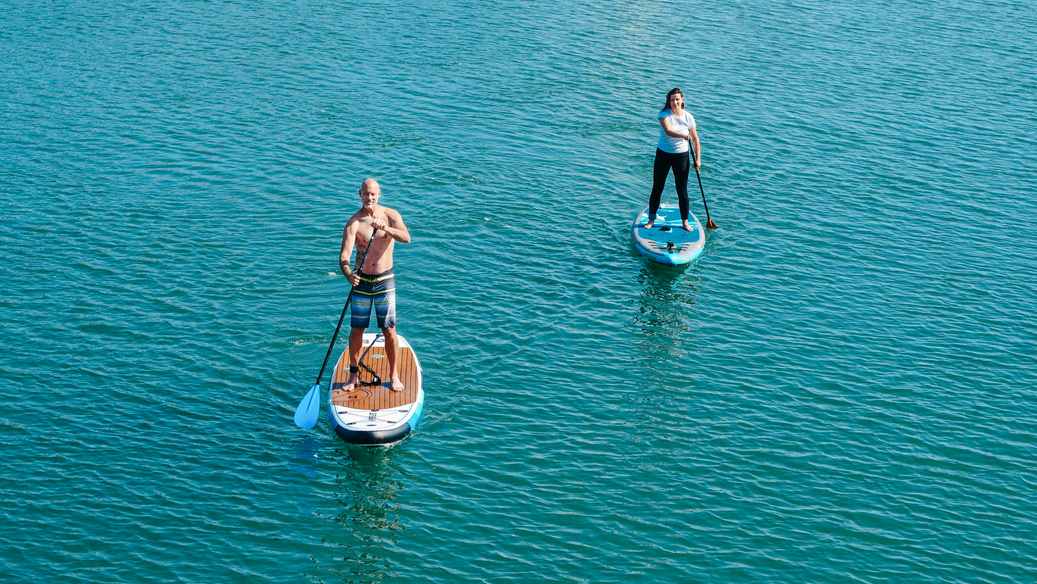A Man and a Woman on Paddleboards